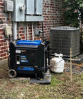 Three Piece Grounding Rod Kit installed with generator beside electrical unit outside brick wall