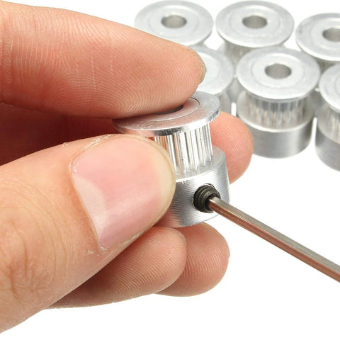 Hand holding GT2 Timing Belt Pulley from GT2 Timing Belt Pulley Kit With Eight Pulleys, 5mm Bore And 20 Teeth, Allen wrench included