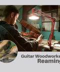 Guitar woodworker using a Tapered Reamer Set With T Handle For Guitar Making And Woodworking, focused on reaming task under lamp.