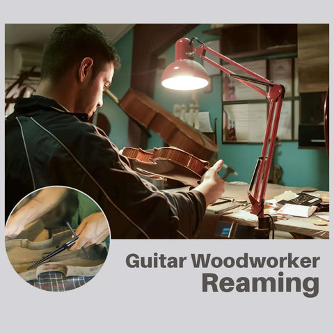 Guitar woodworker using a Tapered Reamer Set With T Handle For Guitar Making And Woodworking, focused on reaming task under lamp.