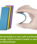 Hand bending Gundam Model Sanding Sponge Kit 400 To 1200 Grit Wet Dry Reusable 30 Sheets showing flexible curved surface use