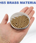 100-Pac Bearing Balls, 6mm Precision H65 Brass Bearing Balls in a hand for Machinery, Automotive, and DIY