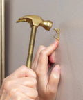Person using the 5 In 1 Hammer With Built In Screwdrivers Chrome Plated To Resist Rust Lightweight Compact Multitool Hammer