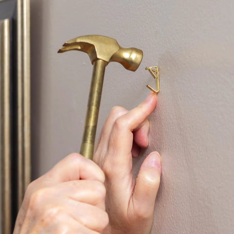 Person using the 5 In 1 Hammer With Built In Screwdrivers Chrome Plated To Resist Rust Lightweight Compact Multitool Hammer