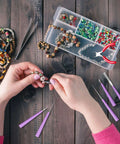 Hands using 10 Piece Bead Reamer Set For Jewelry Making And Beading Diamond Tipped Reamers For Enlarging Holes In Glass