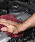 Hand cleaning engine part with red cloth, RTV Silicone Gasket Maker Black Fast Sealant With Low Volatile Formula 7.25 Oz No Cartridge Or Squeeze Tube Needed Easy To Use Bonds Cork Paper Felt Metal And More Case Of 12 nearby.