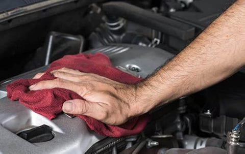 Hand cleaning engine part with red cloth, RTV Silicone Gasket Maker Black Fast Sealant With Low Volatile Formula 7.25 Oz No Cartridge Or Squeeze Tube Needed Easy To Use Bonds Cork Paper Felt Metal And More Case Of 12 nearby.