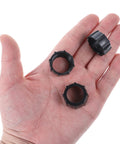 Four Pack 17mm Tightening Nuts For Car Phone Mounts Replacement Parts held in a hand, showcasing compact design and black color