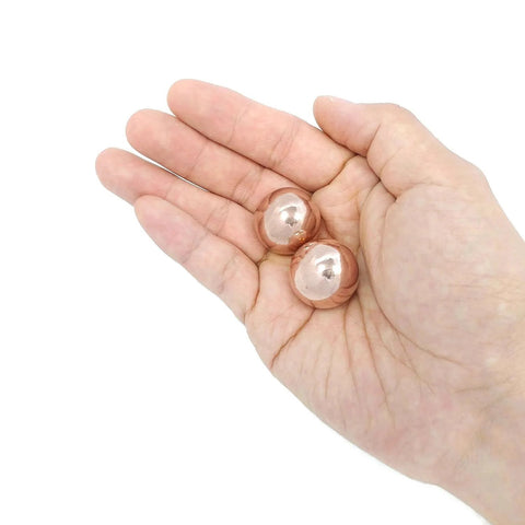 1 inch Solid Copper Baoding Balls with Carry Pouch for Hand Therapy, Exercise, and Stress Relief shown in hand for size comparison