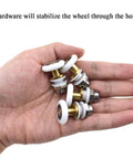 Hand holding 23mm diameter brass shower door wheels with nylon rollers and stainless steel screws