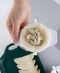 Hand holding No Fuss Dumpling Maker Press Kit 3Pcs small nonstick plastic dumpling mold with filling, showcasing use for pierogi.