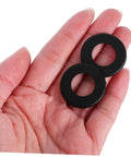 Hand holding black Foosball Table Rod Washers Replacement Set Smooth Easy Install for Standard Foosball Machines Durable Plastic Washers