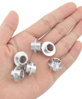 Aluminum Inline Skate Bearing Bushing Spacers Kit 16 Pieces With 8mm Axle Spacers shown in hand for size reference.