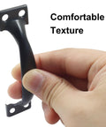Hand holding 4 Pack 4 Inch Metal Door Handles Rustic Bow Pulls With Vintage Arched Design in Matte Black Iron Construction