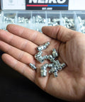 Hand holding zinc plated steel zerks from Grease Fittings Kit With 135-Piece Metric Zerk Assortment For M6-1, M8-1, M10-1.5 by NEIKO