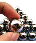 Close-up of Carbon Steel Bearing Balls,Precision Balls with polished finish, held by hand; 9mm to 20mm solid ball options visible