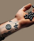 Arm holding 50 x Premium Quality Hard Mix Rubber Steel Balls 2.7 Grams Heavy Reusable Projectiles Paintballs Reballs Powerballs for Training Home Defense Pistols in 50 Caliber (S-Type)