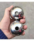 Hand holding two polished 304 stainless steel through-hole balls, part of 10pcs Through Hole Steel Balls 304 Stainless Steel Solid Piercing Balls Dia 3-12.7mm DIY Beading Round Ball(9mm x Hole Dia 3mm) set.