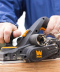 Person using Efficient 3-1/4 inch hand planer with a 6 Amp motor delivers fast, precise planing for doors, trim, and cabinetry on wood