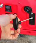 Hand pulling the Two Pack Garage Door Emergency Release Pull Rope Kit with plastic handle for attic door and ladder access