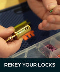 Person using Ultimate Rekey Kit For Schlage Locks With 50 Master Pins And Seal Tight Box for rekeying locks