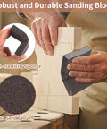 Person using Eight Pack Hand Sanding Block Set Grits 60 80 120 220 for Wood Metal Drywall on wooden surface