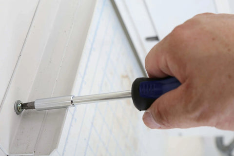 Close-up of a person using a screwdriver from the 121 Piece Mechanic Tool Set With One Quarter And Three Eighth Inch Drive Sockets