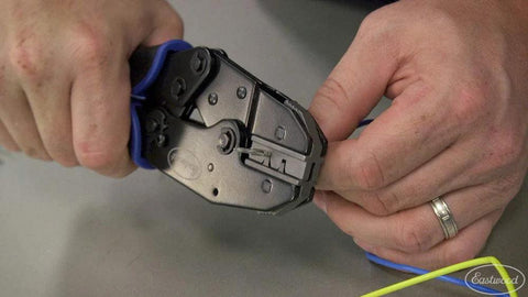 Hands using Crimp Right Weather Tight Connector Crimping Kit Ferrule Crimper Plier Wire Stripper for wiring projects and repairs.
