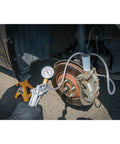 hand vacuum pump for brake bleeding in use on car brake system