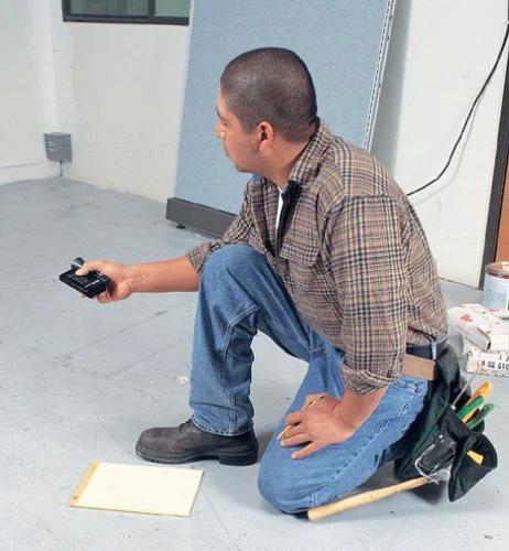 Man using Precision Handheld Ultrasonic Distance Meter For Fast Measurements With A 50 Foot Range That Quickly Displays Length Area And Volume In A Compact Unit Ideal For Painters Builders Flooring Pros And DIY Enthusiasts DM S50 in a room