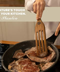 Spurtle Kitchen Tools Wooden Set For Nonstick Cookware in use with acacia wooden spatula flipping steaks in a frying pan.