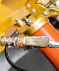 Hands Free Lock On Grease Gun Coupler With Cleaning Tool, 14000 PSI Quick Release, shown in use on machinery with 5/8 inch size.