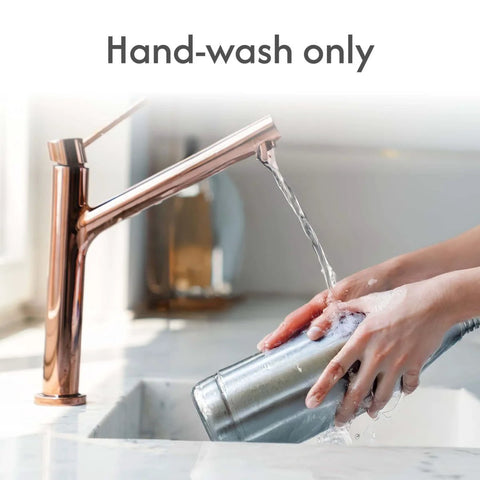 Washing Officially Licensed 24 Oz Smart Grip Tumbler For Seattle Seahawks Fans with water, highlighting hand-wash instruction.