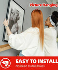 Two women using Heavy Duty Double Sided Foam Tape 0.39 Inch Wide By 9.85 Feet Long Removable Mounting Tape to hang a picture.