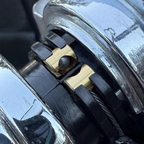 Close-up of throttle idle cable ferrules for Harley Davidson carburetor installed on a bike's throttle cable end joint guide nut