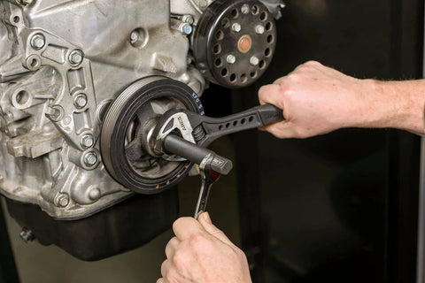 Master Harmonic Balancer Install Kit for Domestic and Import Vehicles with installation tools in use on engine
