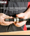 Person holding Master Harmonic Balancer Install Kit for domestic and import vehicles with extra long installers.