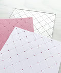 Heart Hole Rectangular Metal Die Cuts For DIY Scrapbooking And Card Making, Rhombus Hole Background Cutting Dies Stencils, Silver Carbon Steel Embossing Dies 14x11 cm displayed with embossed pink and white papers