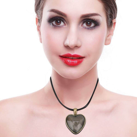 Woman wearing heart pendant from DIY Necklace Making Kit with Base Tray Pendant Molds and 60pc Metal and Plastic Accessories for Crafting