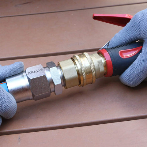 Heavy Duty Built Tough Three Quarters Inch Full Flow Garden Hose Quick Connect Fittings Lead Free Brass Full Port Connectors Coupler connected to a garden hose with a nozzle.