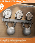 Image of heavy-duty double-sided wall tape holding kettlebells, showcasing grip strength on smooth surfaces for home or office decor.