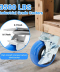 Close-up of 5 inch heavy duty caster wheel with polyurethane wheel and thick bracket, rated 3500 lb, installed on wooden cart.