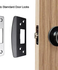Heavy duty oversized door strike plate with 2mm hardened steel and an enlarged strike hole alongside wooden door with lock