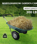 Heavy Duty Dual Wheel Garden Wheelbarrow Cart with Built In Stand holding straw, 300 lbs capacity, on grass