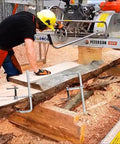 Person using Heavy Duty 12 Inch F Clamp Set 4 Pack For Welding Woodworking And Metalworking 1320 Lb Load Capacity on a wooden plank.