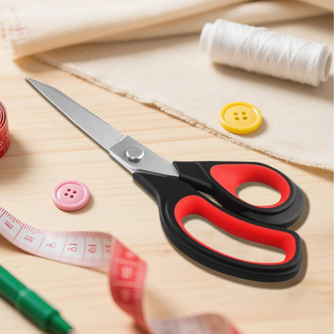 Heavy Duty All Purpose Fabric Scissors For Sewing And Garment Making With Stainless Steel Blades on a sewing table with measuring tape and thread.