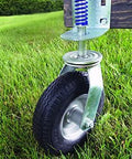 Heavy Duty Flat Free Spring Gate Caster With Universal Mount Eight Inch Wheel installed on wooden gate in grass