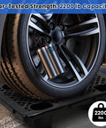 Car tire resting on Beefy Heavy Duty Interlocking Plastic Pallets With Breathable Grids For Storage In Garage Warehouse Supermarket Restaurant And Kitchen, 8 Pack, 23.6 x 15.7 x 4.7 In, Black, showing strength test