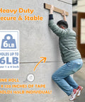 Man climbing wall using Heavy Duty Double Sided Nano Tape Removable Mounting Tape 1 Inch Wide Clear Adhesive Strips for outdoor use