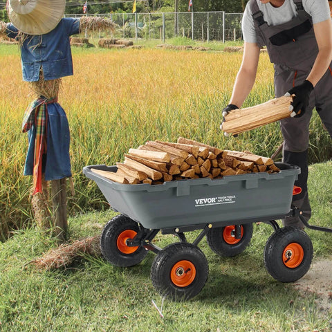 Man using 800 lb Poly Dump Garden Cart Heavy Duty Yard Dump Wagon 4 Wheel Wheelbarrow with Steel Frame loaded with firewood in a field.